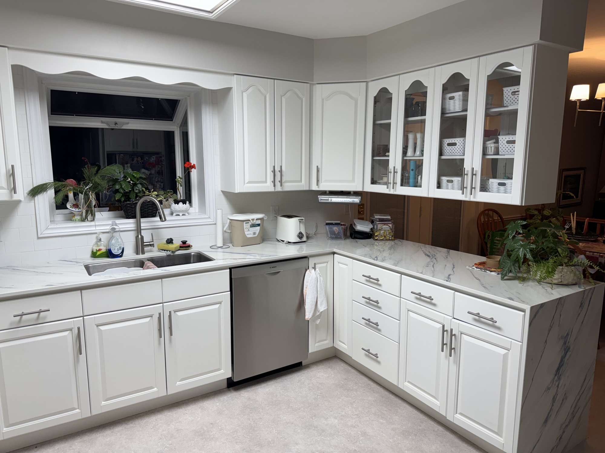 Kitchen makeover with sleek countertop waterfall. - After