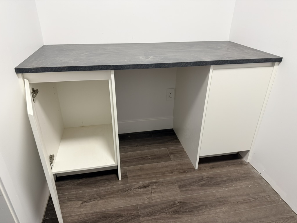 Walk-in closet with custom cabinets and shelving.