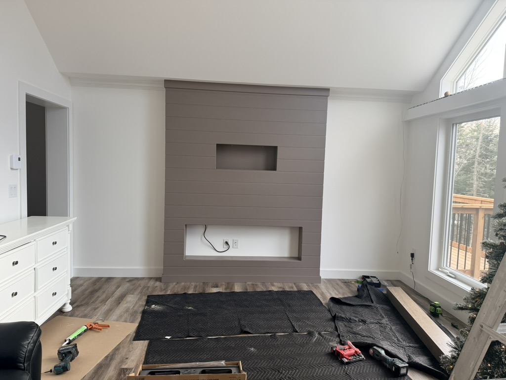 Electric fireplace mantel with TV.